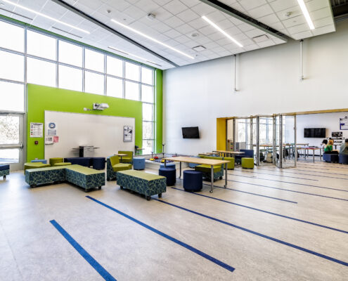 Learning Hub Space for Students to Collaborate or Conduct Experiments from their Adjacent Lab Classroom (i.e., robotics in the back right of the photo)