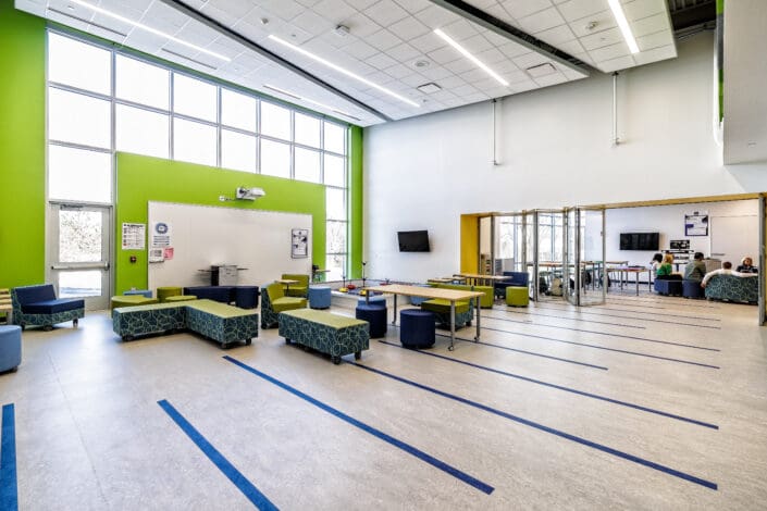 Learning Hub Space for Students to Collaborate or Conduct Experiments from their Adjacent Lab Classroom (i.e., robotics in the back right of the photo)